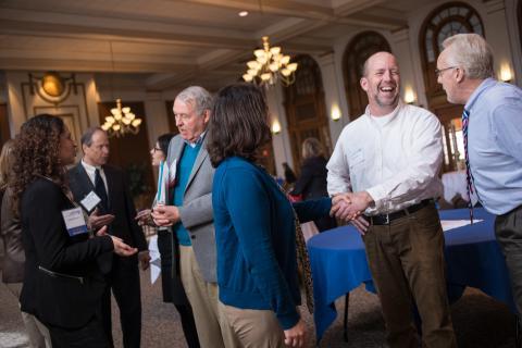 UNH faculty talking in the Huddleston Ballroom