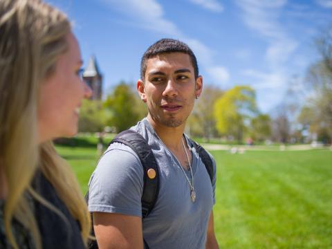 two people talking in front of thompson hall unh